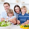 Cheerful young family cooking together